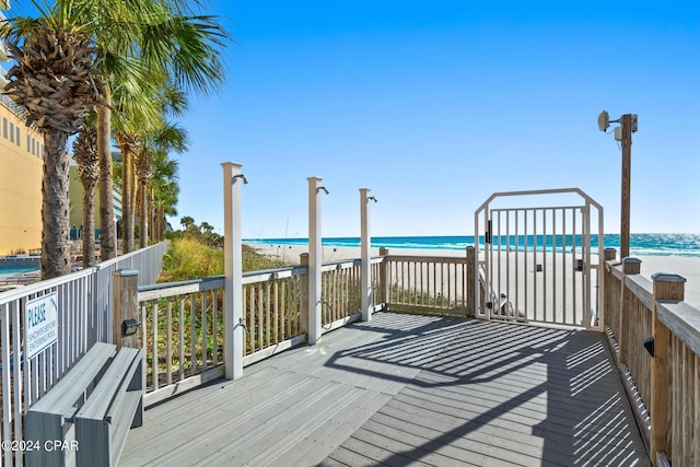 wooden terrace with a beach view and a water view