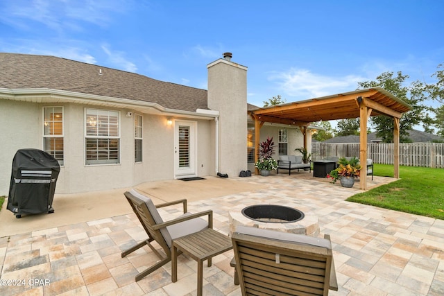 view of patio / terrace with a fire pit and a grill