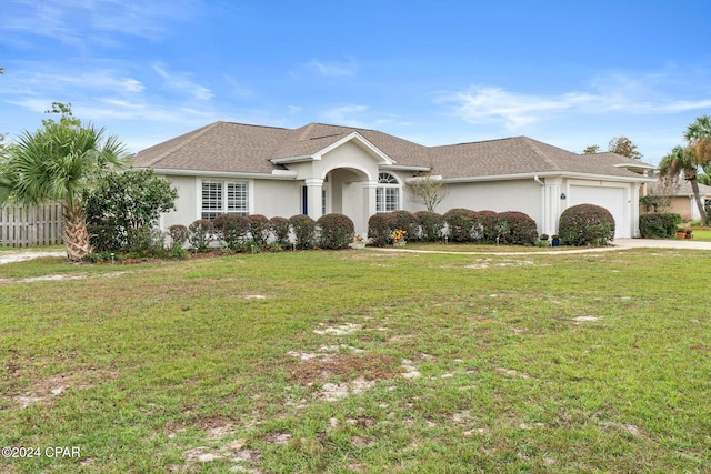 ranch-style house featuring a garage and a front yard