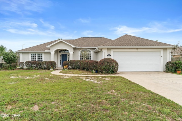 single story home with a front yard and a garage