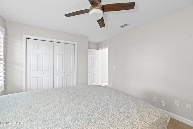 unfurnished bedroom with carpet, a closet, and ceiling fan