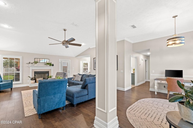 living room with ceiling fan with notable chandelier, a textured ceiling, dark hardwood / wood-style flooring, and lofted ceiling