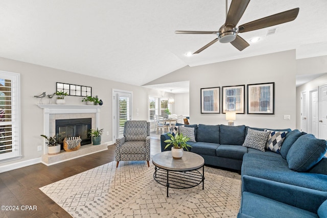 living room featuring a fireplace, dark hardwood / wood-style flooring, ceiling fan, and lofted ceiling