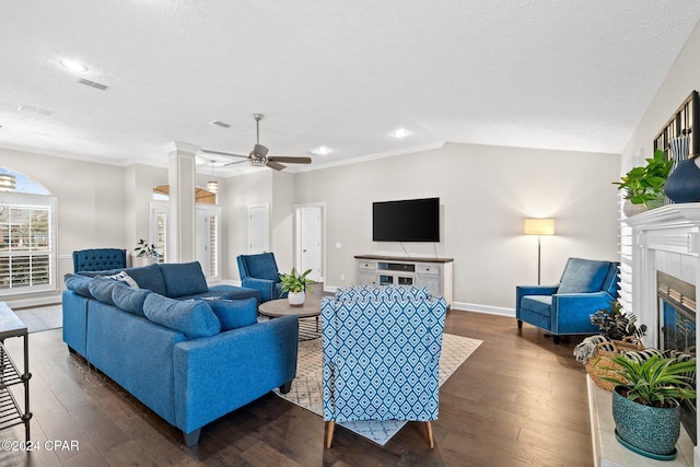 living room featuring a tile fireplace, lofted ceiling, ceiling fan, and dark hardwood / wood-style floors