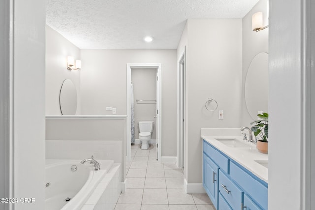 bathroom with tile patterned flooring, a relaxing tiled tub, a textured ceiling, and toilet