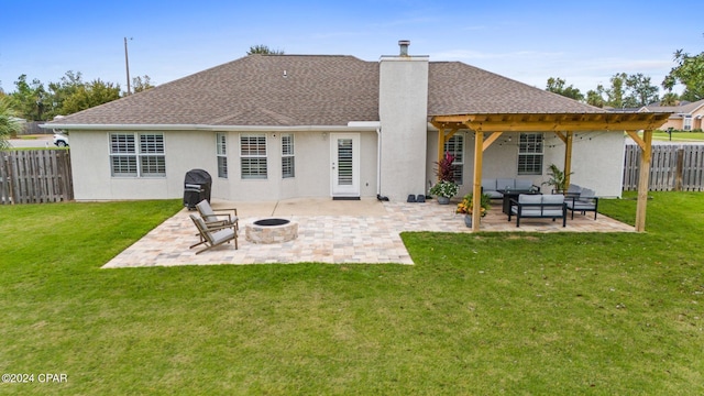 back of property with an outdoor living space with a fire pit, a yard, and a patio