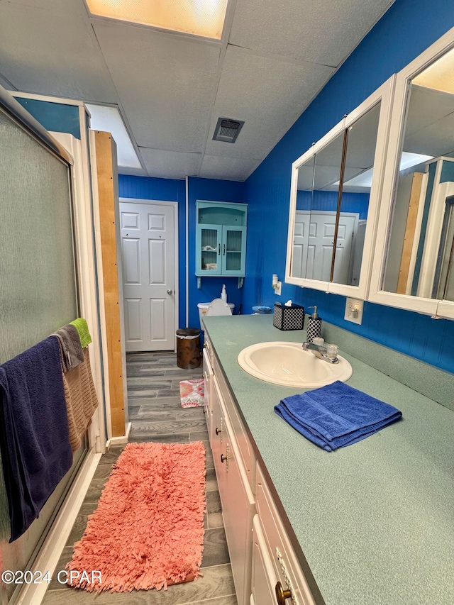 bathroom featuring vanity, hardwood / wood-style flooring, and walk in shower