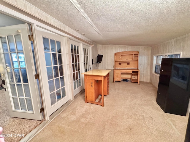 home office with light carpet, french doors, and a textured ceiling