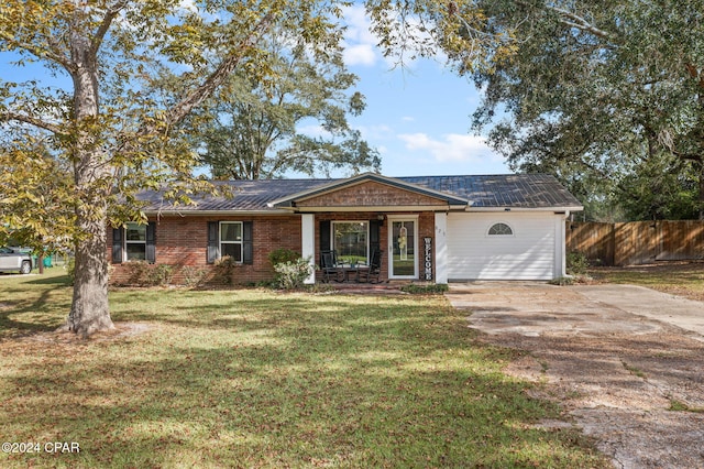 single story home featuring covered porch, a garage, and a front lawn