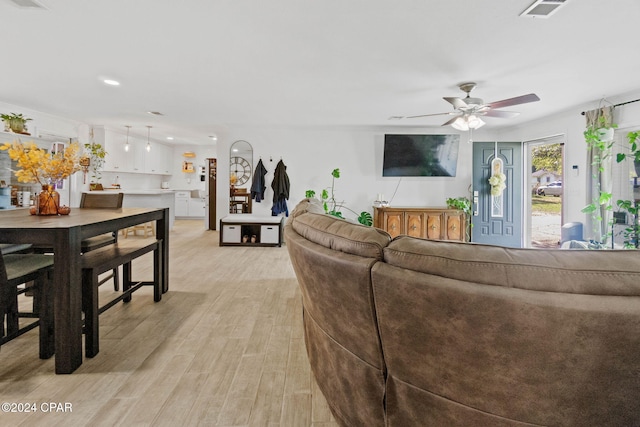 living room featuring ceiling fan and light hardwood / wood-style floors