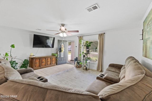 living room with crown molding, hardwood / wood-style floors, and ceiling fan