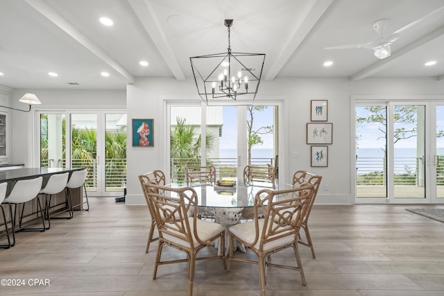 dining room with beam ceiling, ceiling fan with notable chandelier, and light wood-type flooring