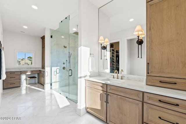 bathroom with vanity and a shower with shower door