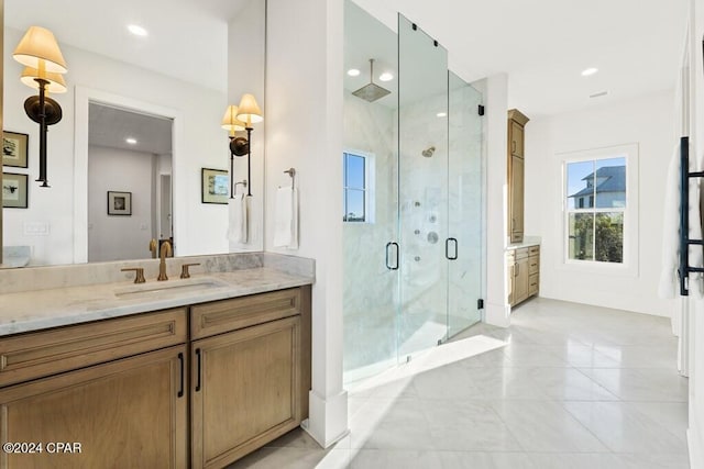 bathroom with vanity and a shower with shower door