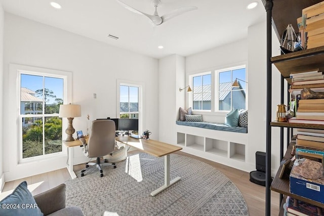 office with ceiling fan, plenty of natural light, and wood-type flooring