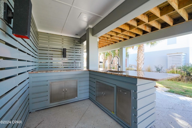 exterior space featuring kitchen peninsula and sink