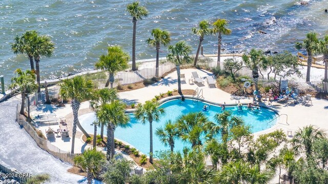 view of swimming pool featuring a patio area and a water view