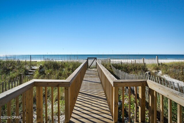 view of home's community with a water view and a view of the beach