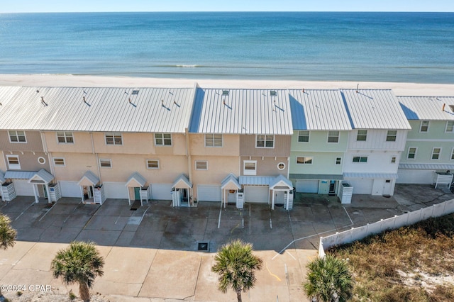 bird's eye view with a water view and a beach view