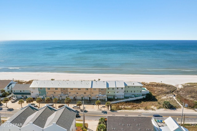 drone / aerial view featuring a beach view and a water view