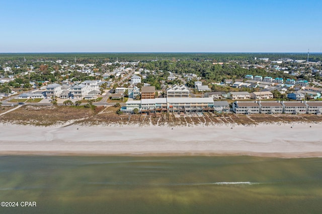 birds eye view of property with a water view and a view of the beach