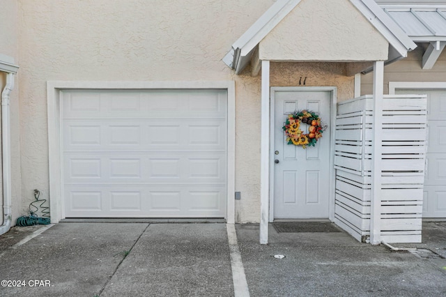 view of exterior entry featuring a garage