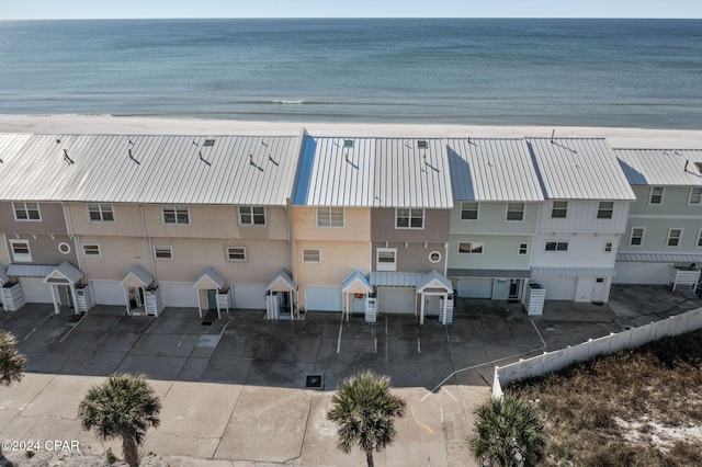 birds eye view of property with a beach view and a water view