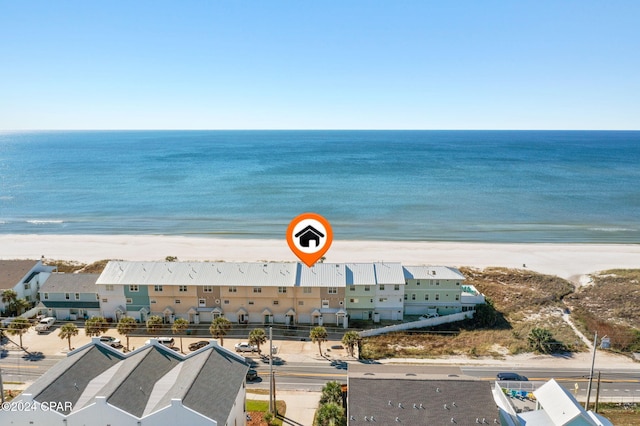 birds eye view of property featuring a water view and a beach view