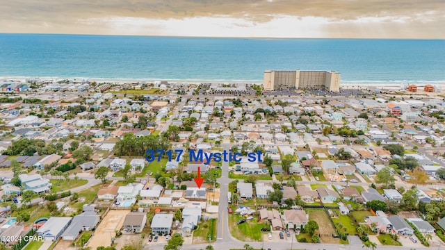 aerial view with a water view and a beach view