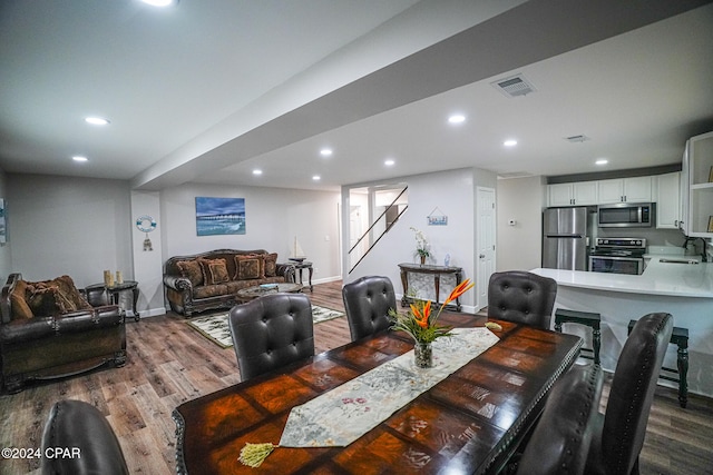 dining area with wood-type flooring and sink