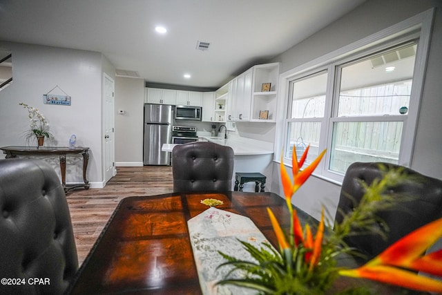 living room with wood-type flooring and sink