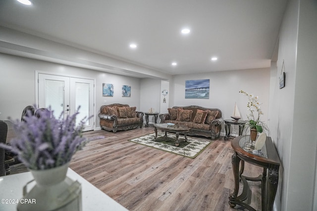 living room with french doors and light hardwood / wood-style flooring