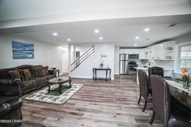 living room featuring sink and light wood-type flooring