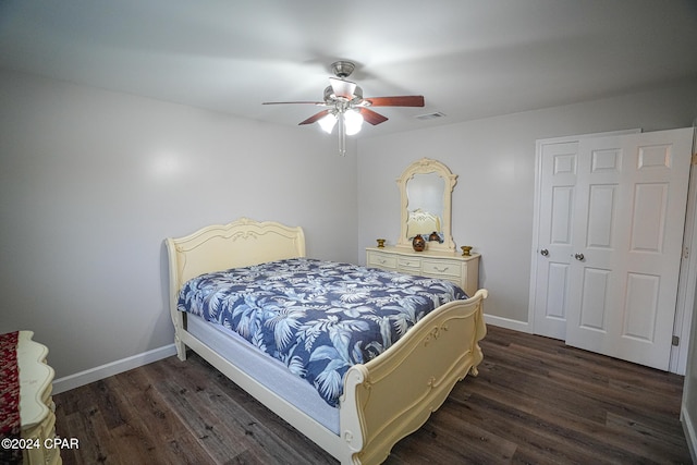 bedroom with dark hardwood / wood-style flooring and ceiling fan