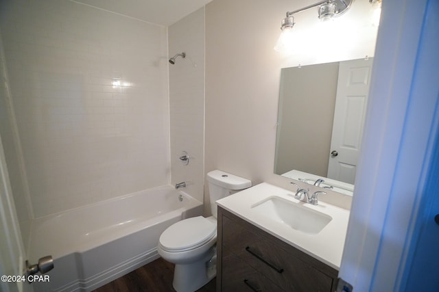 full bathroom featuring vanity, tiled shower / bath combo, hardwood / wood-style flooring, and toilet