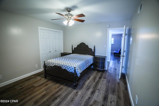 bedroom featuring a closet, dark wood-type flooring, and ceiling fan