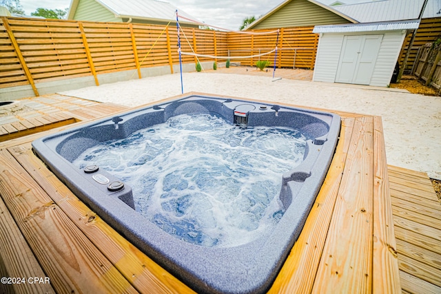 view of swimming pool with a shed and a deck