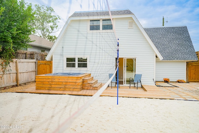 back of house featuring a wooden deck