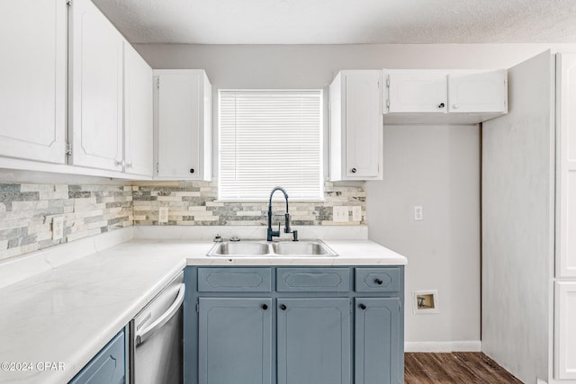 kitchen with dishwasher, backsplash, white cabinets, sink, and dark hardwood / wood-style floors