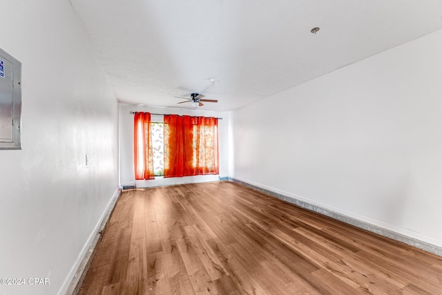 unfurnished room with hardwood / wood-style flooring and ceiling fan