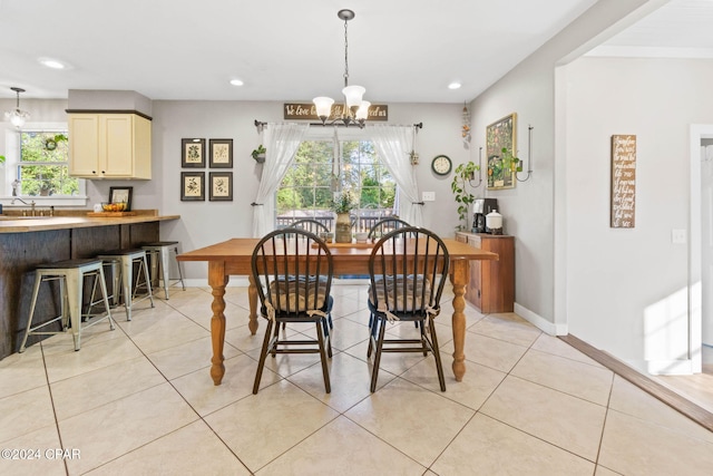 tiled dining room with an inviting chandelier and sink