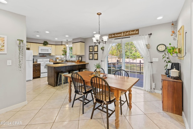 dining room with light tile patterned floors, a notable chandelier, and sink