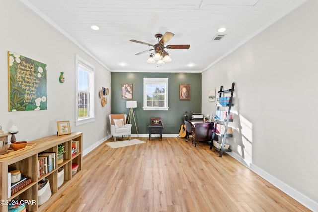 sitting room with light hardwood / wood-style floors, ceiling fan, and ornamental molding