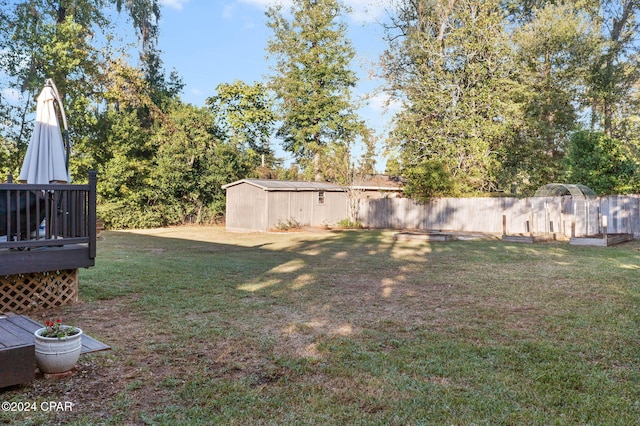 view of yard with a storage unit and a deck