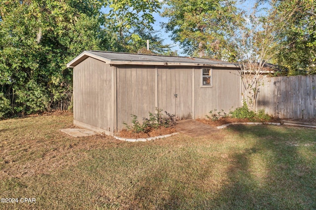 view of outbuilding with a yard