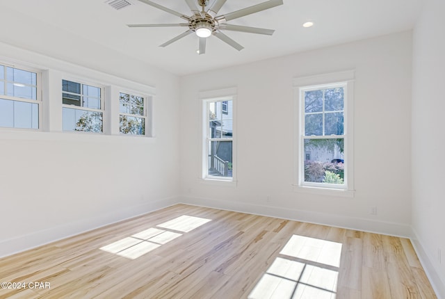 spare room with ceiling fan and light wood-type flooring