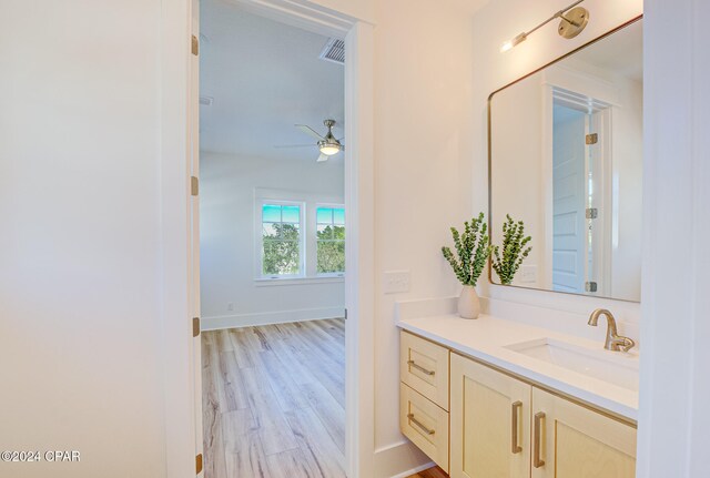 bathroom with ceiling fan, vanity, and wood-type flooring