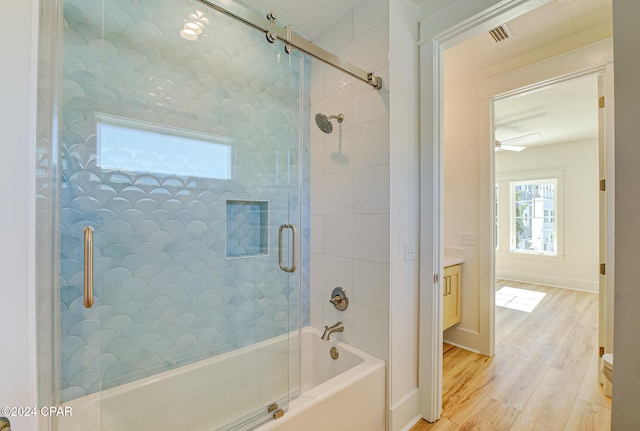 bathroom featuring combined bath / shower with glass door, vanity, and hardwood / wood-style flooring