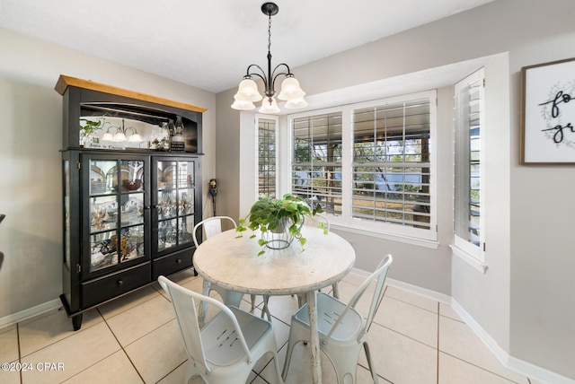 dining area featuring a notable chandelier and light tile patterned flooring