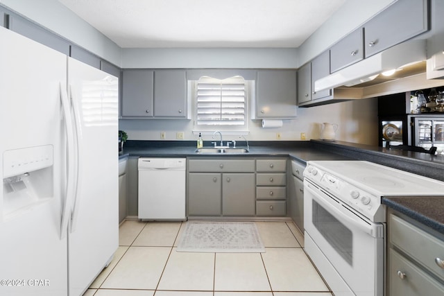 kitchen featuring gray cabinets, white appliances, sink, and light tile patterned floors